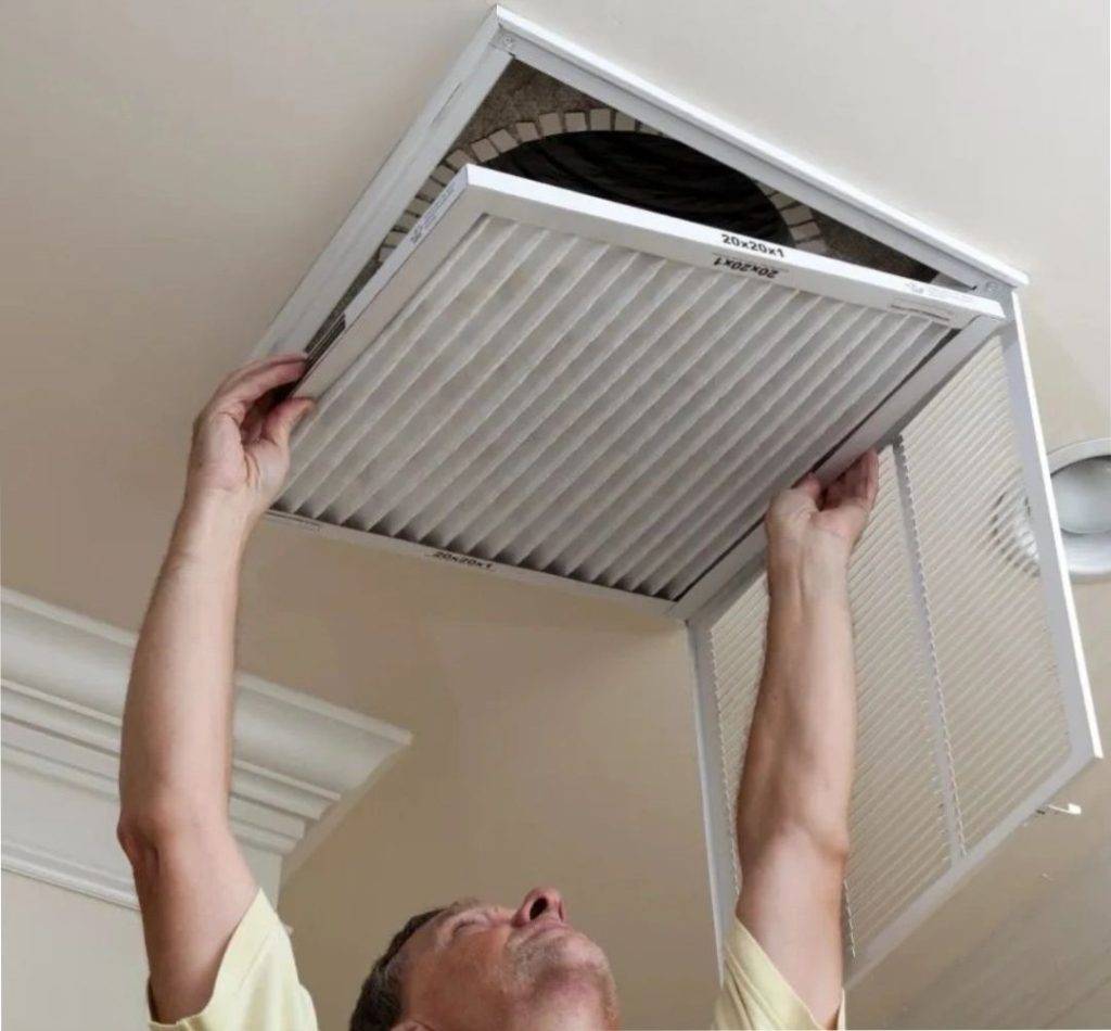Hands cleaning dirty air vent register
